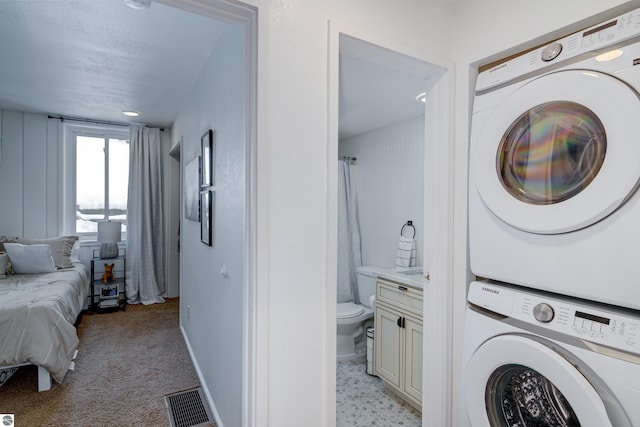 laundry room with stacked washer and clothes dryer and light colored carpet