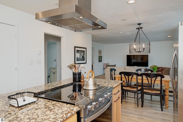 kitchen featuring stainless steel range with electric stovetop, island exhaust hood, light hardwood / wood-style floors, light stone countertops, and light brown cabinets