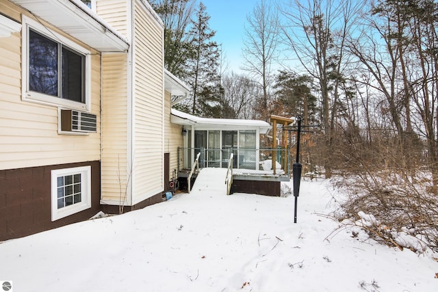 exterior space featuring a sunroom and a wall unit AC