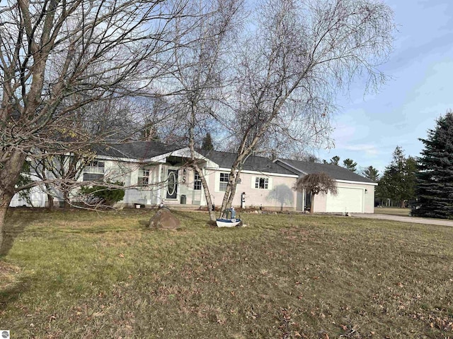 view of front of property featuring a garage and a front lawn