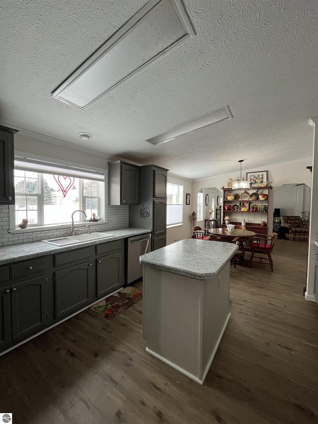 kitchen with sink, gray cabinetry, stainless steel dishwasher, dark hardwood / wood-style flooring, and pendant lighting