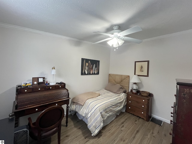 bedroom featuring crown molding, a textured ceiling, and light wood-type flooring