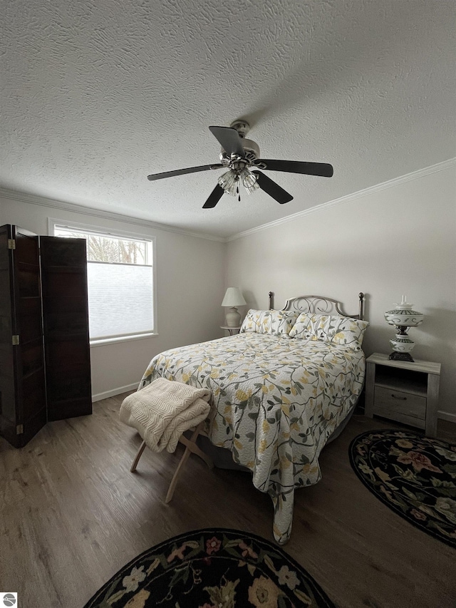 bedroom with crown molding, hardwood / wood-style floors, a textured ceiling, and ceiling fan