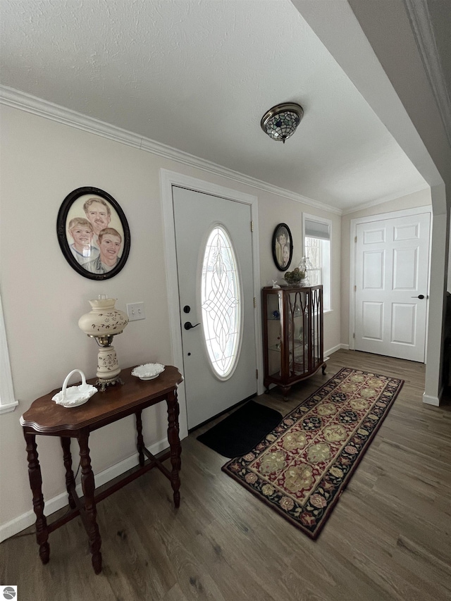 foyer featuring ornamental molding, dark hardwood / wood-style floors, and a textured ceiling