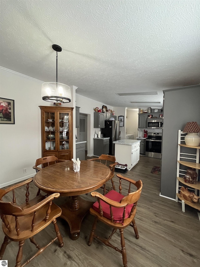 dining area with dark hardwood / wood-style flooring and a textured ceiling