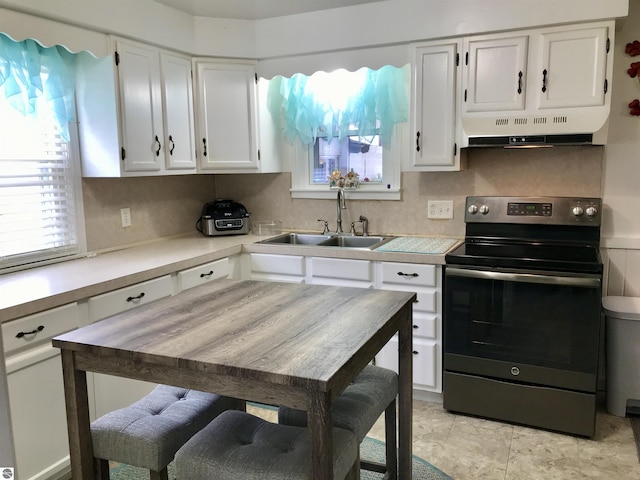 kitchen featuring white cabinets, sink, exhaust hood, and electric range