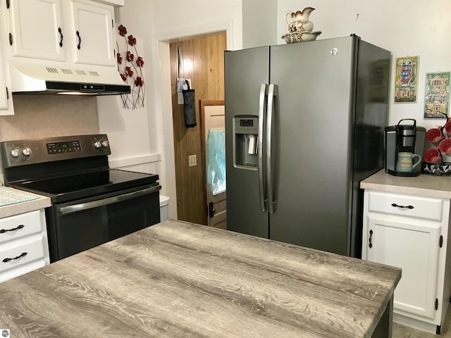 kitchen featuring white cabinetry, stainless steel fridge with ice dispenser, and electric range oven