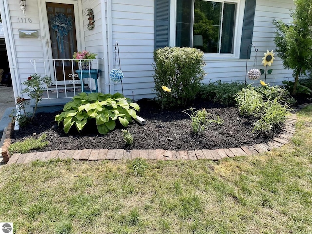 doorway to property with a lawn