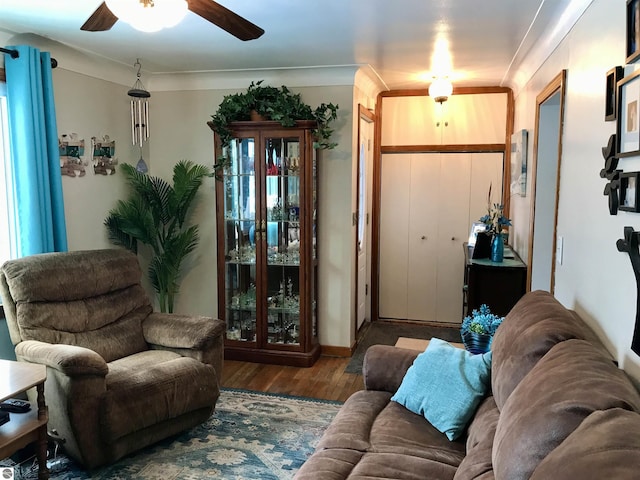 living room featuring dark hardwood / wood-style flooring and ceiling fan