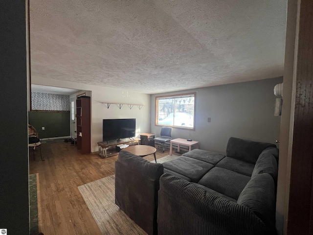 living room with hardwood / wood-style flooring and a textured ceiling