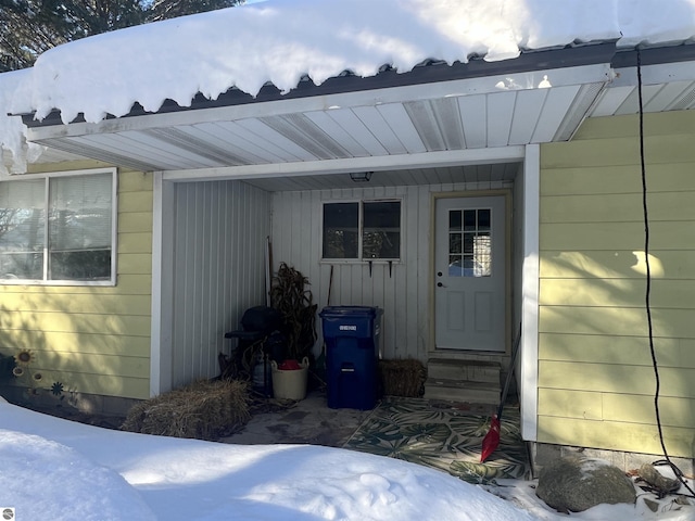 view of snow covered property entrance