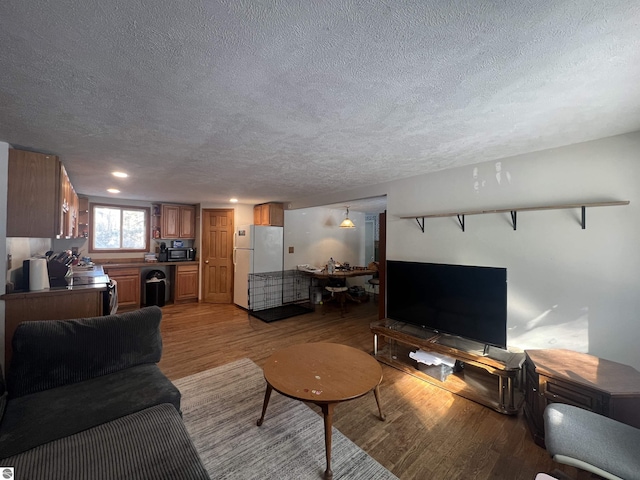 living room with light hardwood / wood-style flooring and a textured ceiling