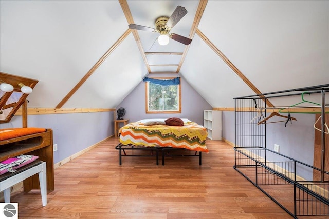 bedroom featuring lofted ceiling and light wood-type flooring