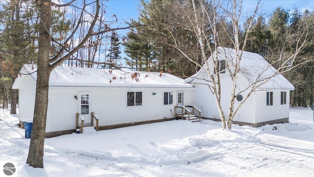 view of snow covered back of property