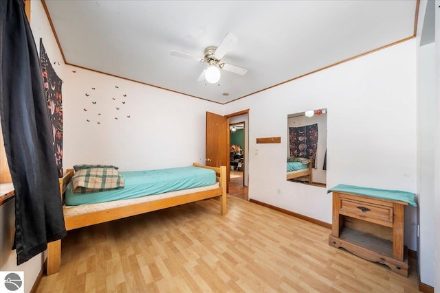 bedroom with light hardwood / wood-style flooring, ornamental molding, and ceiling fan