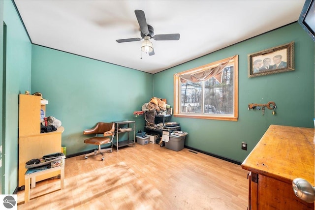 home office with hardwood / wood-style flooring and ceiling fan