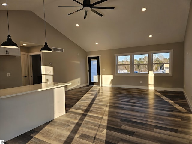 interior space with ceiling fan, dark hardwood / wood-style floors, and high vaulted ceiling