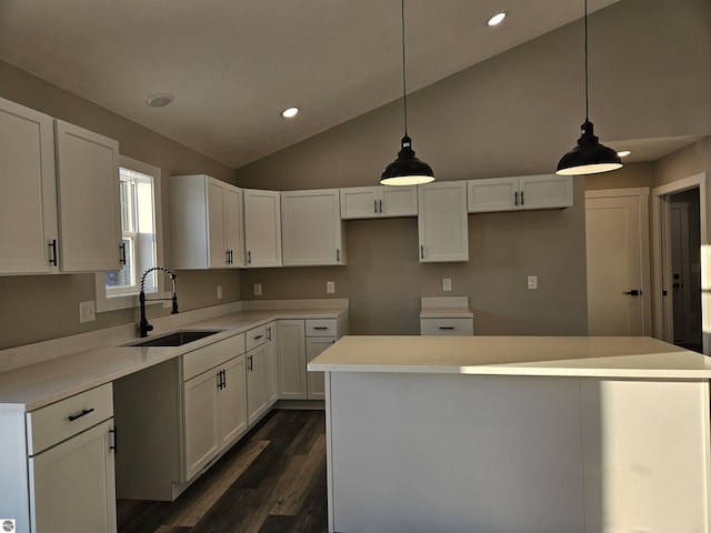 kitchen featuring white cabinetry, sink, pendant lighting, and a kitchen island