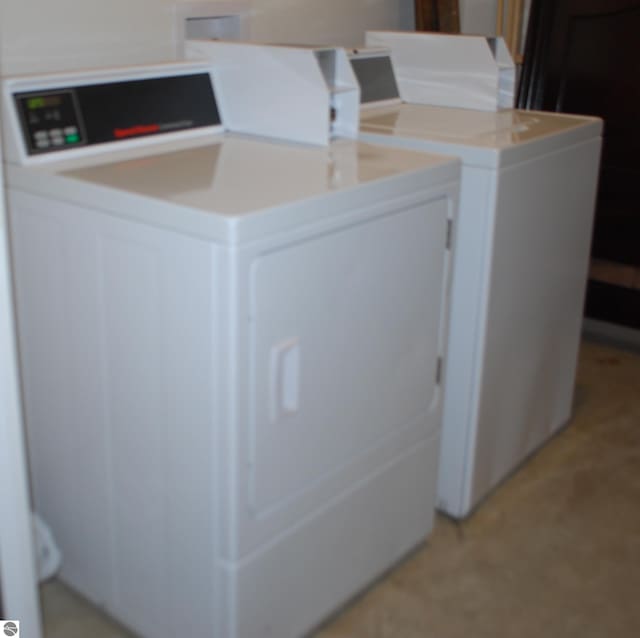 clothes washing area with washer and dryer