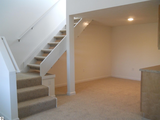 staircase with carpet floors