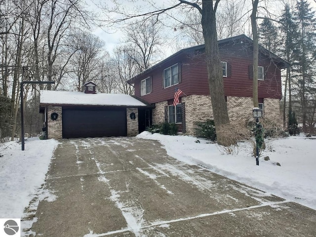 view of snow covered exterior featuring a garage