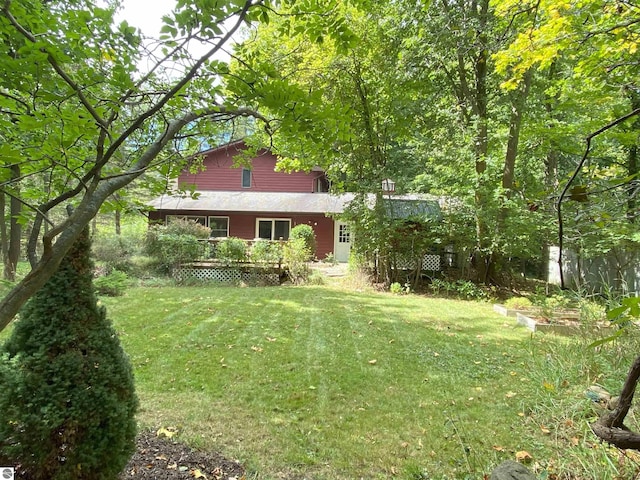 view of front property with a deck and a front yard