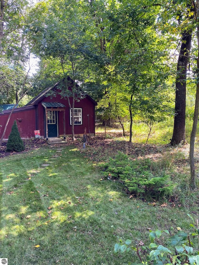 view of outbuilding with a lawn