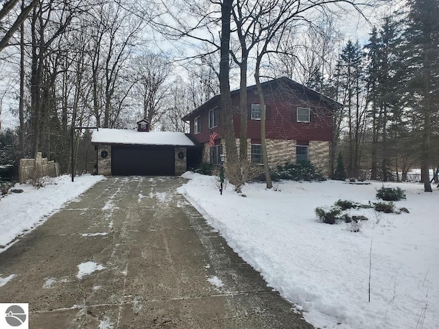 view of snowy exterior with a garage