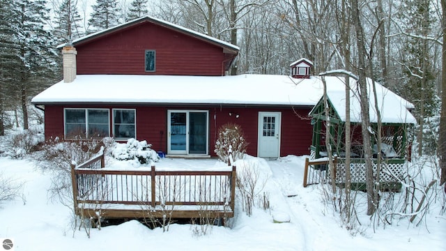 view of snow covered back of property