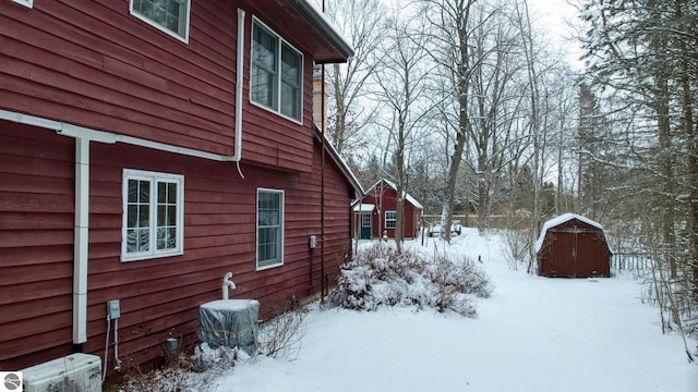 snow covered property featuring ac unit