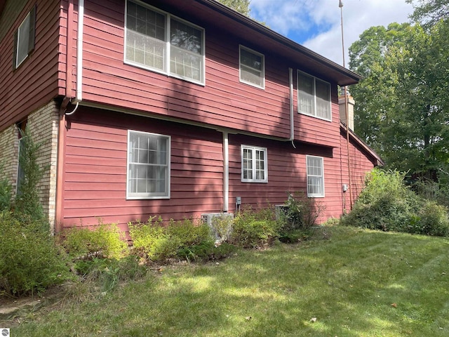 view of side of property with a yard