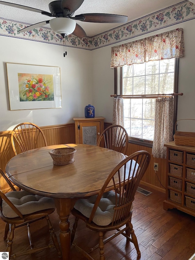 dining area with dark hardwood / wood-style floors and ceiling fan