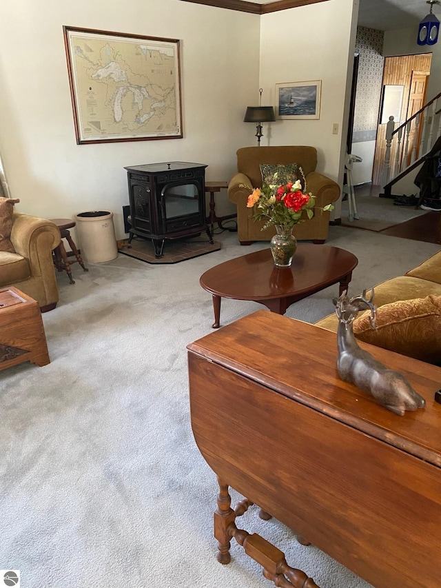 living room with a wood stove and light carpet