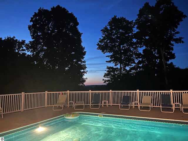 view of pool at dusk