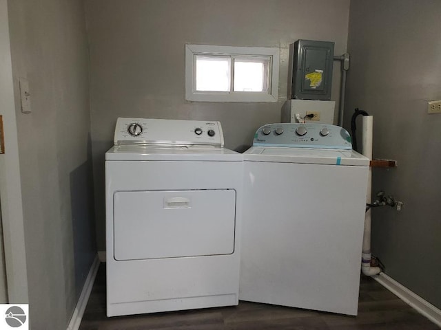 clothes washing area with washing machine and dryer and dark wood-type flooring