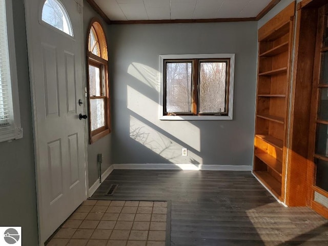 entryway featuring ornamental molding and dark hardwood / wood-style flooring