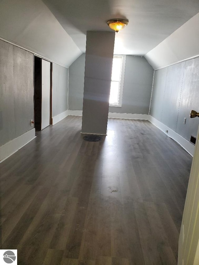 bonus room featuring vaulted ceiling and dark hardwood / wood-style floors