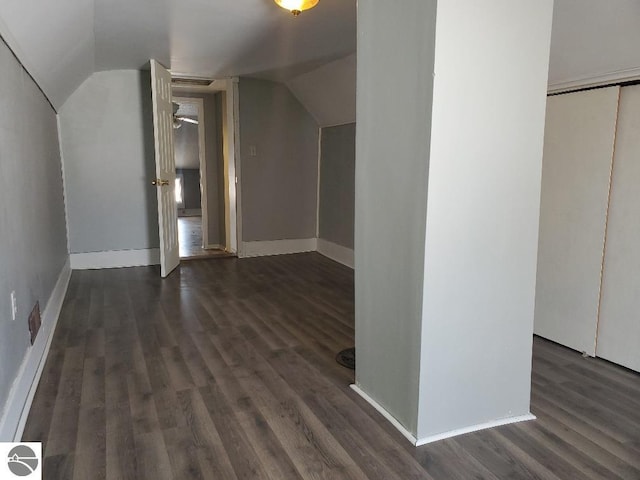 bonus room with lofted ceiling and dark hardwood / wood-style flooring