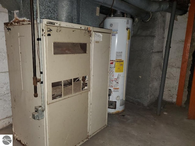 utility room featuring heating unit and gas water heater