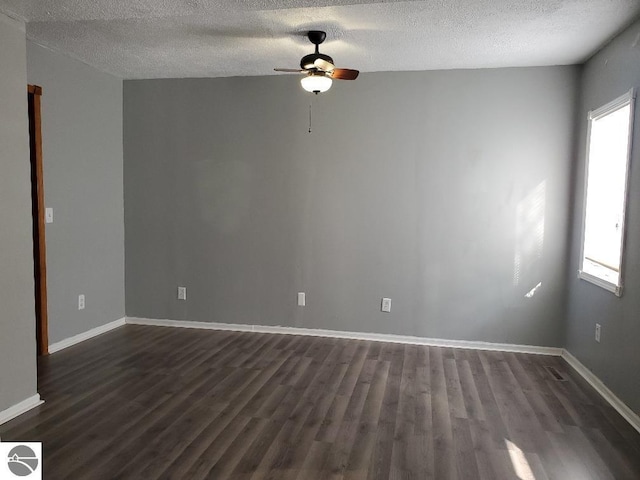 unfurnished room featuring ceiling fan, dark hardwood / wood-style floors, and a textured ceiling