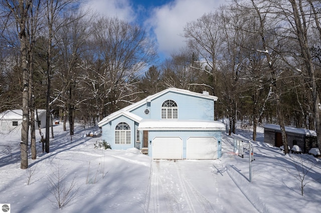 snow covered property featuring a garage