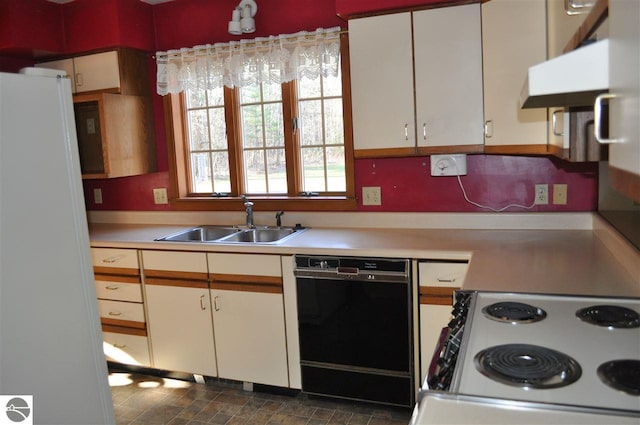 kitchen with white cabinets, white appliances, light countertops, and a sink