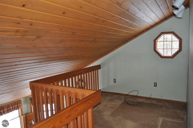 additional living space featuring lofted ceiling, dark colored carpet, wood ceiling, and baseboards