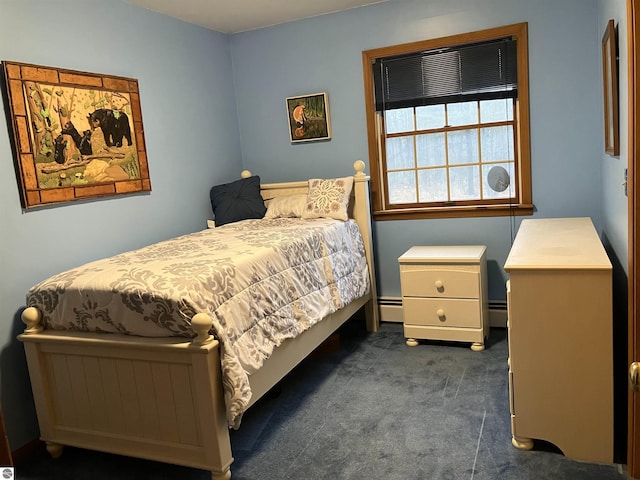 bedroom featuring a baseboard heating unit and dark colored carpet