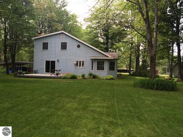 back of property featuring a lawn