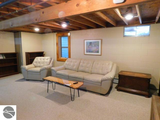 carpeted living area featuring a baseboard radiator