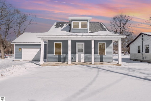 view of front of property with a garage and covered porch