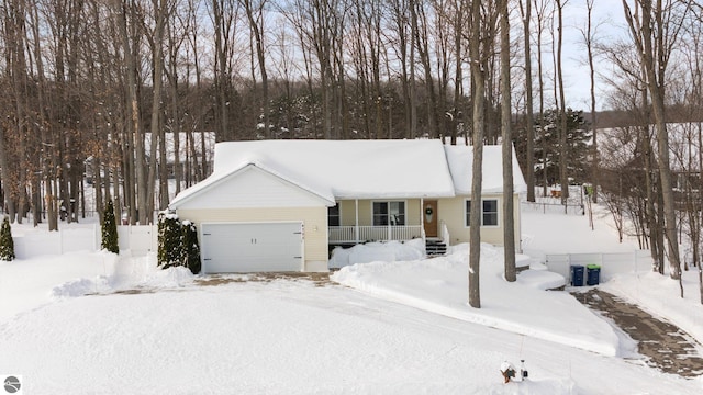 single story home featuring a garage and covered porch