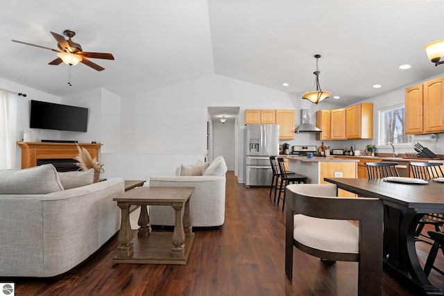 living room with lofted ceiling, dark hardwood / wood-style floors, sink, and ceiling fan