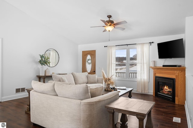 living room with vaulted ceiling, dark hardwood / wood-style floors, and ceiling fan